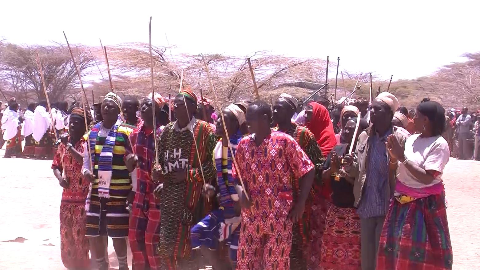 Community members in blue traditional dress at Kalacha